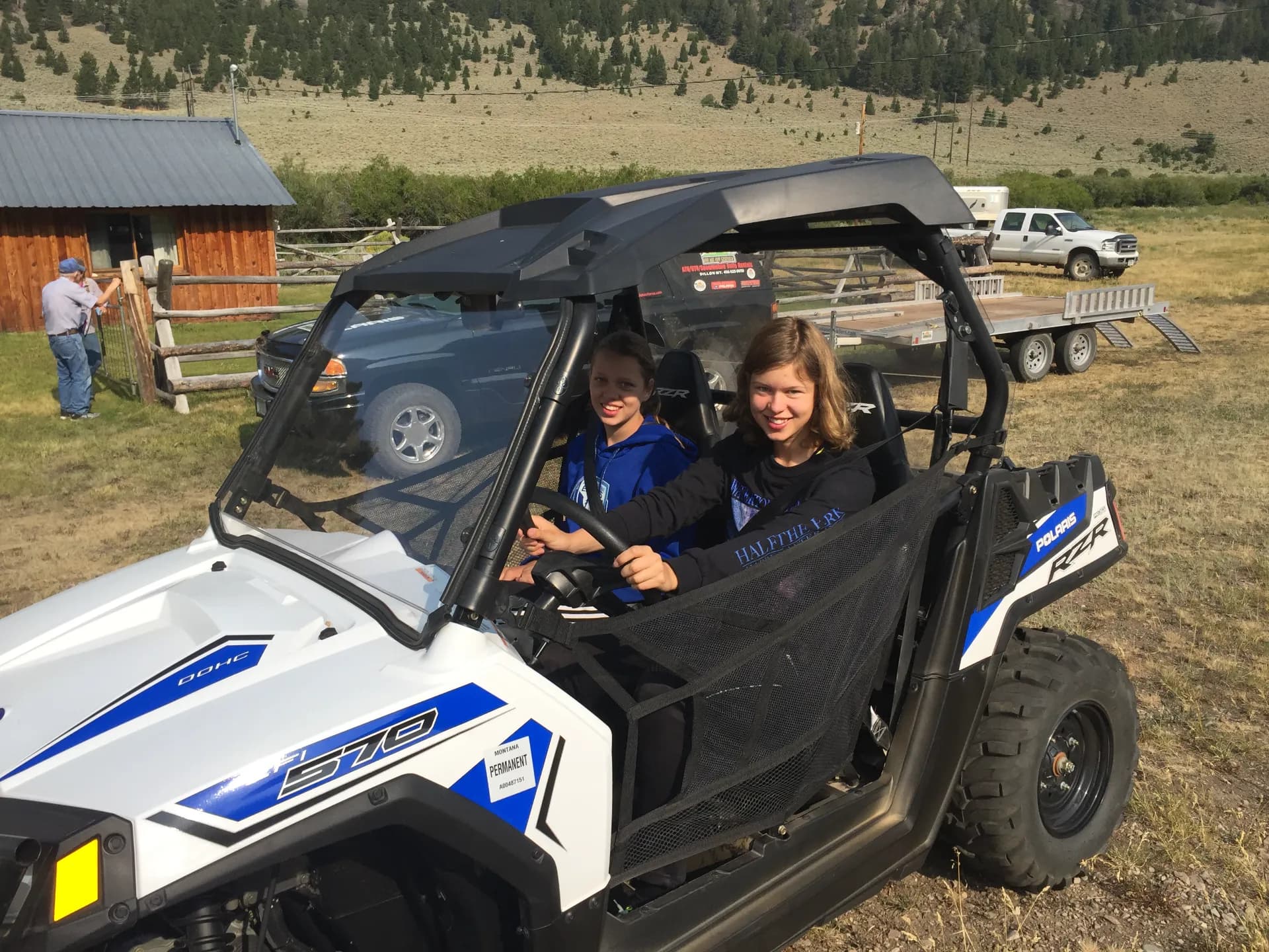Riders in a Polaris RZR side-by-side