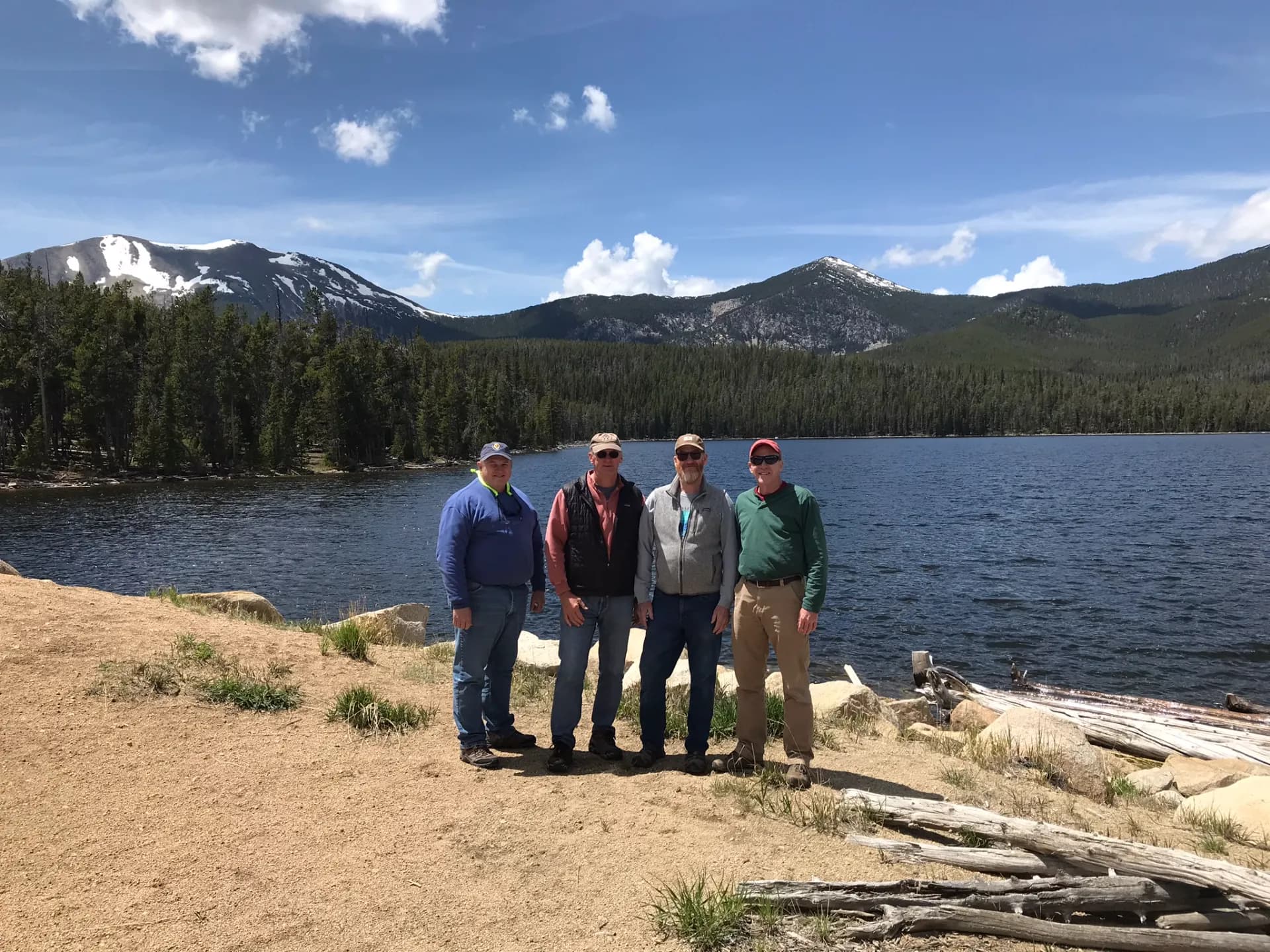 Riders by an alpine lake after a Polaris adventure