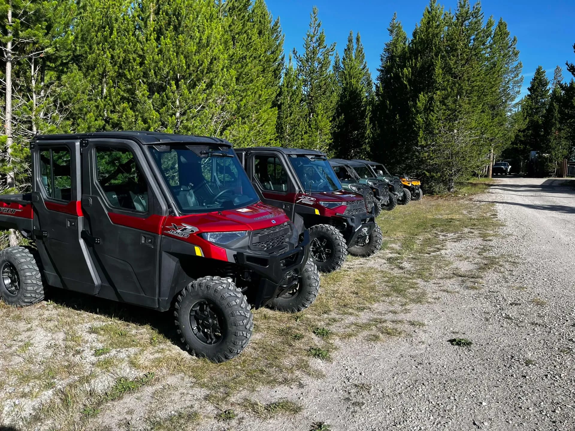 Lineup of Polaris Ranger side-by-sides on a Montana trail
