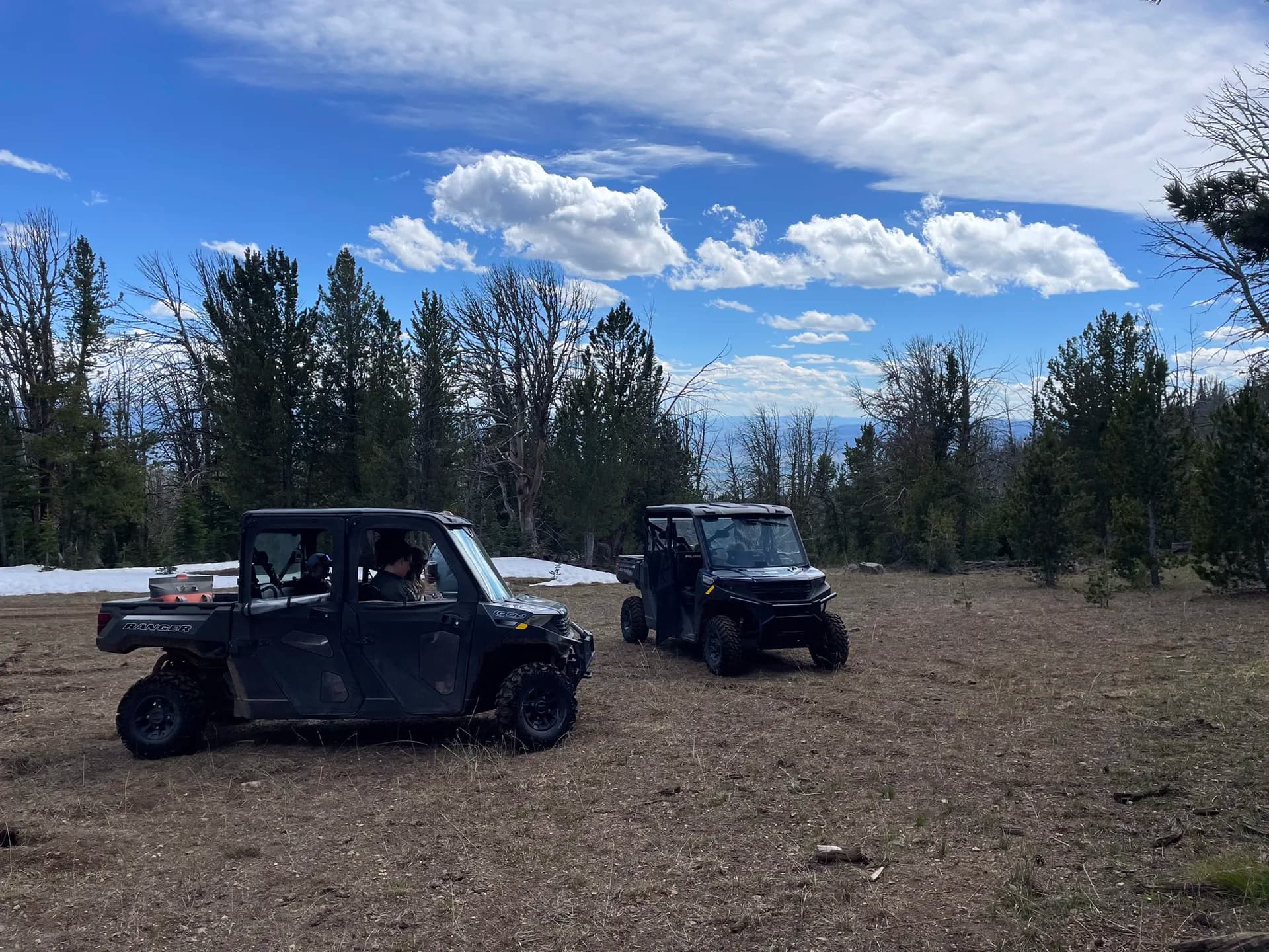 Polaris Ranger side-by-sides on a backcountry ridge