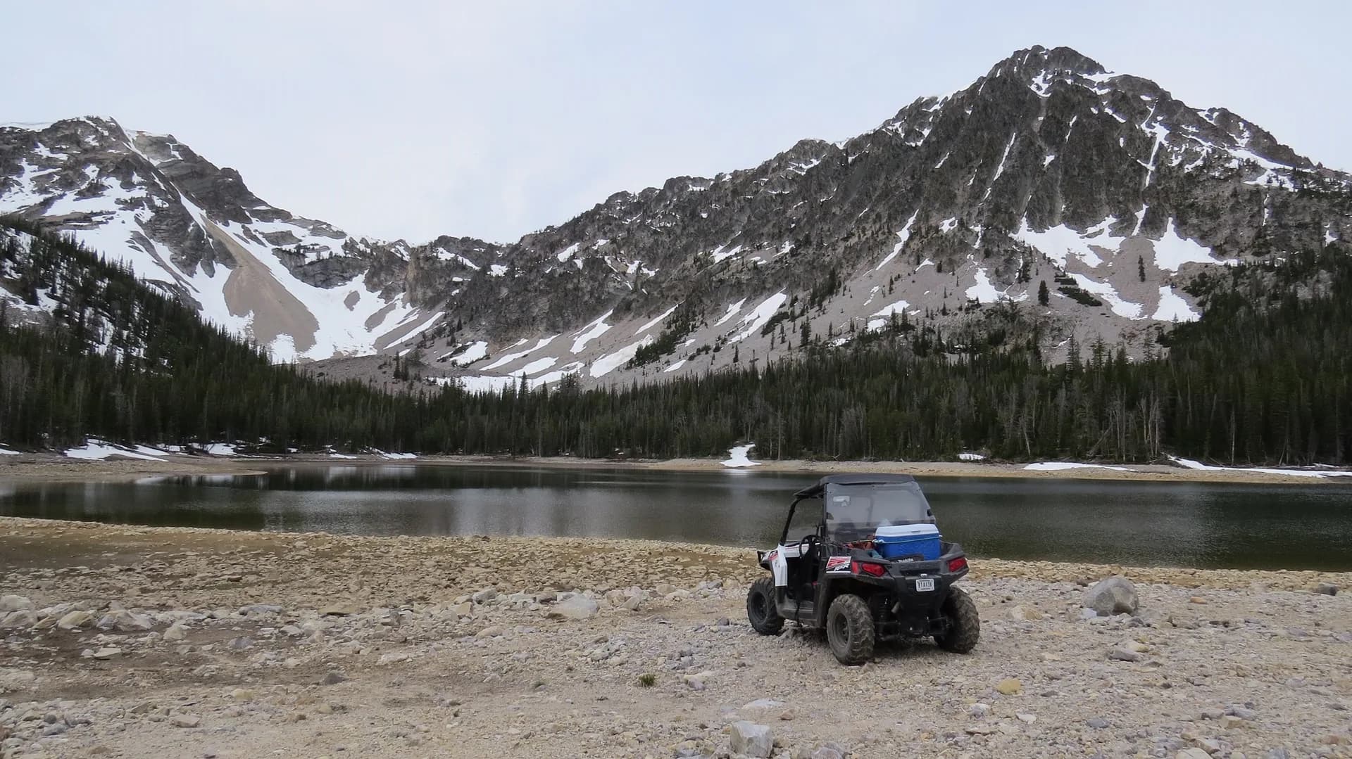 Polaris RZR beside an alpine lake in the Montana mountains